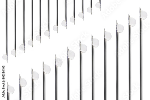 Needles of syringes and vaccine droplets on white background, closeup, isolated
