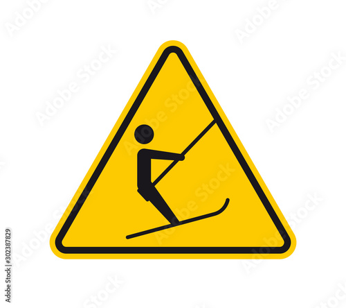 Vector yellow triangle sign - black silhouette figure with skis riding on ski lift. Isolated on white background.