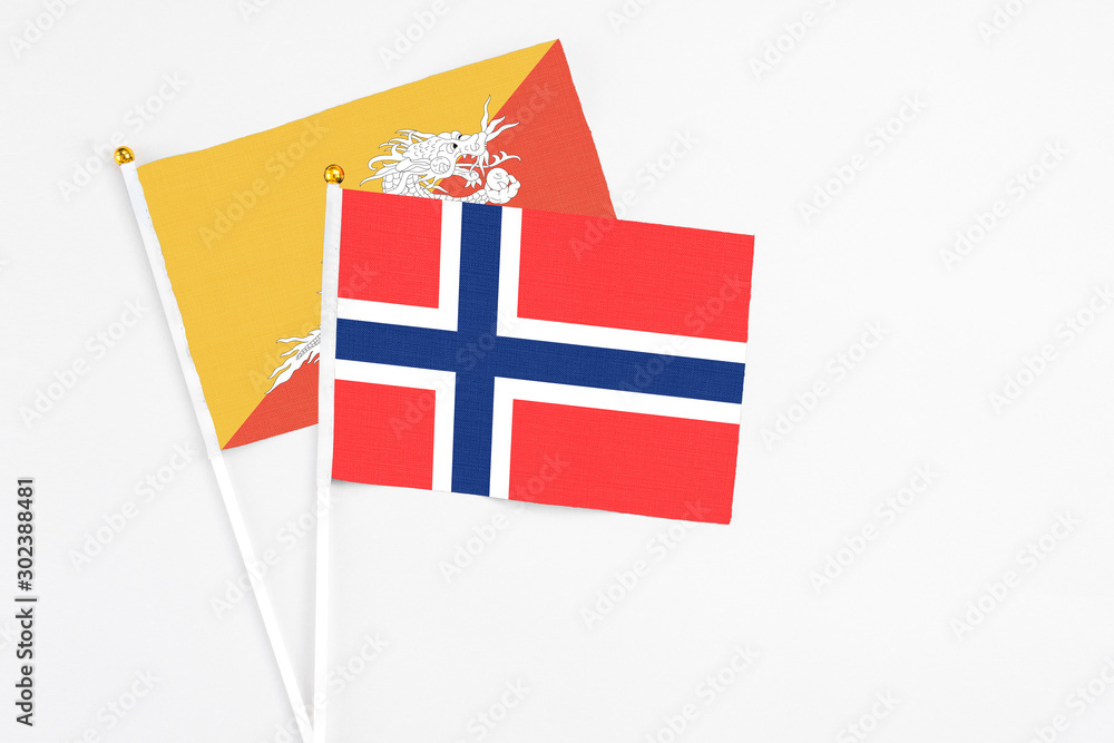 Bouvet Islands and Bhutan stick flags on white background. High quality fabric, miniature national flag. Peaceful global concept.White floor for copy space. Bouvet Islands and Bhutan stick flags on white background. High quality fabric, miniature national flag. Peaceful global concept.White floor for copy space.