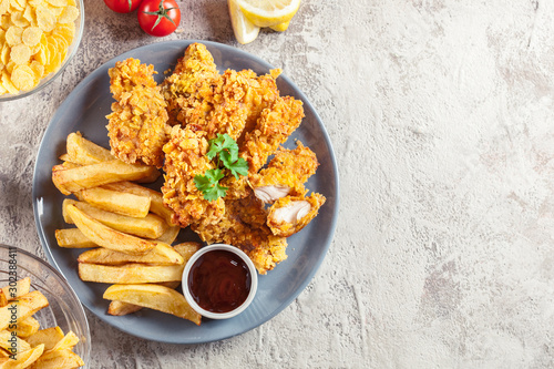 Obraz na płótnie Chicken strips in cornflakes breadcrumb