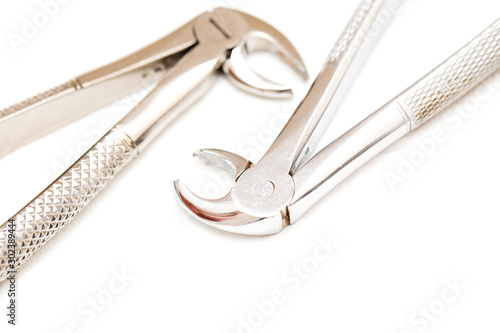 Dental forceps for removing teeth on a white isolated background. photo