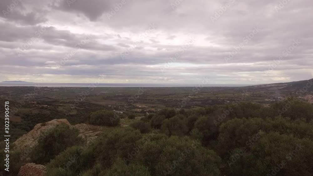 aerial view from above on the valley of valledoria badesi santa maria coghinas with the background of the sea and the Mediterranean maquis with heavy clouds aerial view from above on the valley of valledoria badesi santa maria coghinas with the background of the sea and the Mediterranean maquis with heavy clouds