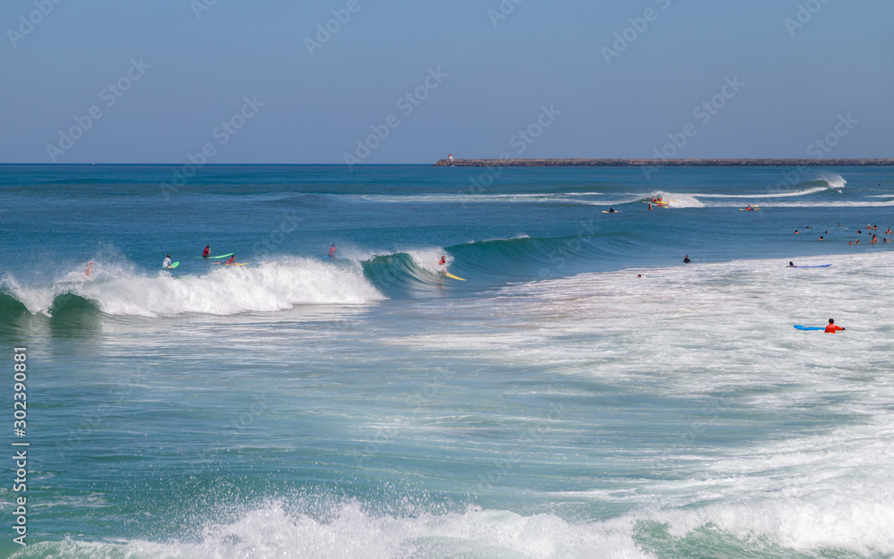 Biarritz, Atlantic ocean, active holidays. Surfers in the ocean.