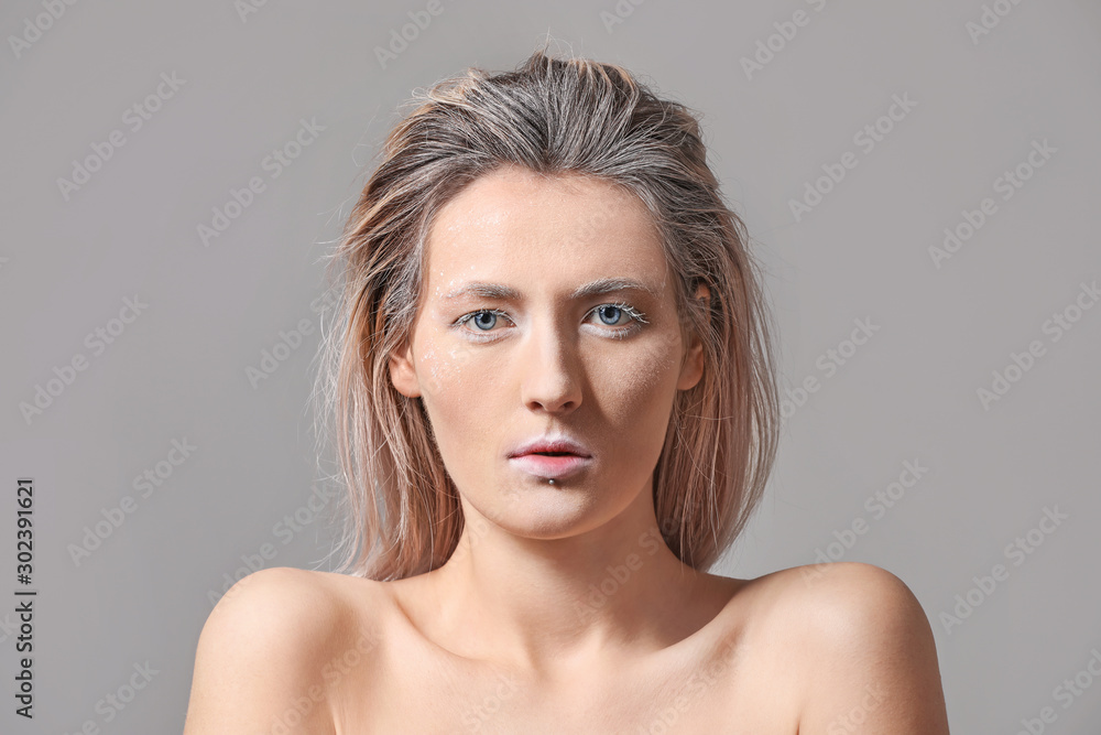 Beautiful woman with creative makeup on grey background Beautiful woman with creative makeup on grey background