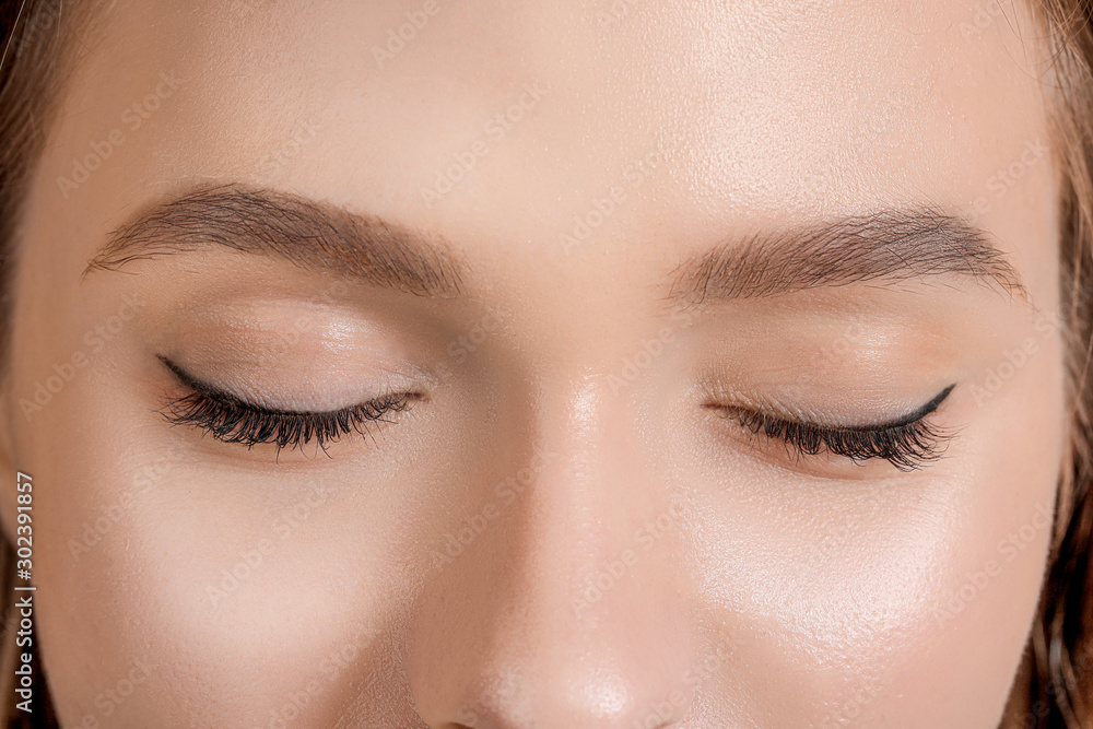 Young woman with beautiful eyebrows, closeup