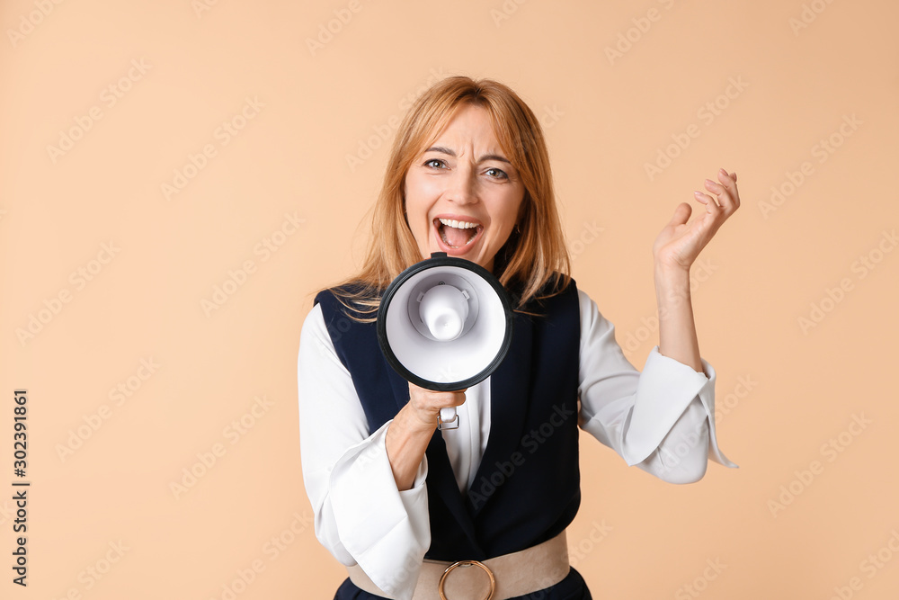 Fototapeta premium Mature woman with megaphone on color background