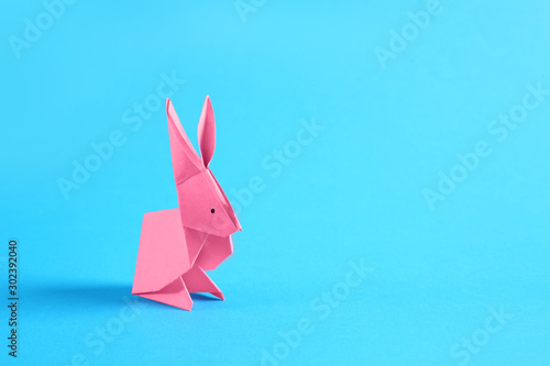 Origami rabbit on color background