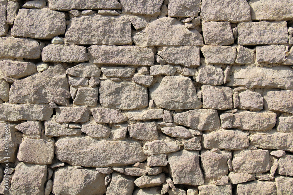 Detail of a wall made of rubble stone Detail of a wall made of rubble stone