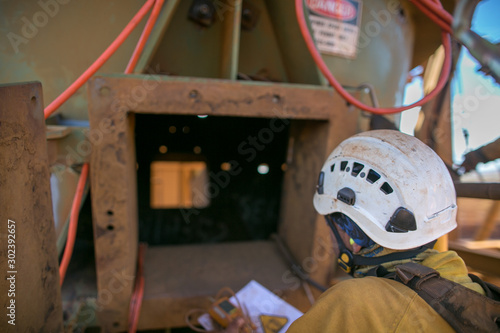 Certifies miner wearing fall body harness helmet protection holding gas test detector confined space permit book and inspecting safety environment surrounding before conduct gas testing prior entry