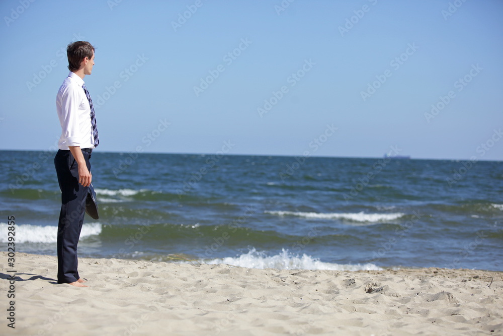 Caucasian business man dealing with emotional stress at the sea Caucasian business man dealing with emotional stress at the sea