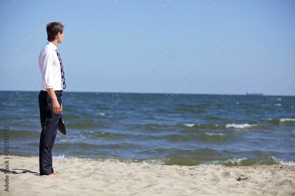 Caucasian business man dealing with emotional stress at the sea