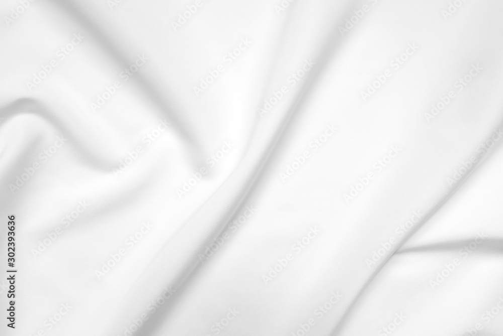 Obraz premium Abstract white fabric texture background. Cloth soft wave. Creases of satin, silk, and cotton.