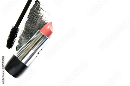 Lipstick and mascara on white background. The concept of fashion and beauty industry. Close up. - Image