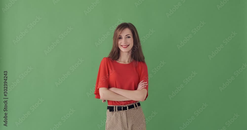 Rear view of beautiful young woman turning around over green background Rear view of beautiful young woman turning around over green background