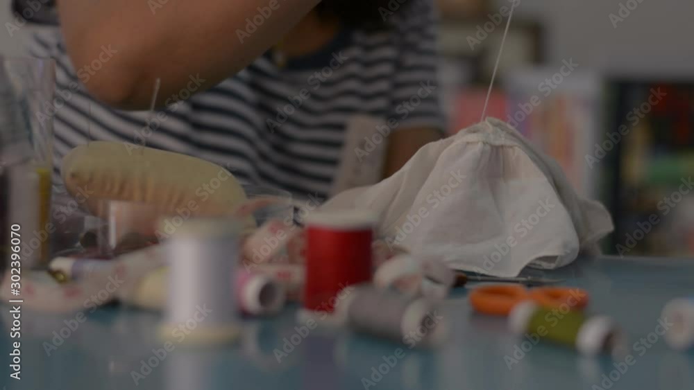 Woman sewing and fixing a cloth at home. House works. Woman sewing and fixing a cloth at home. House works.