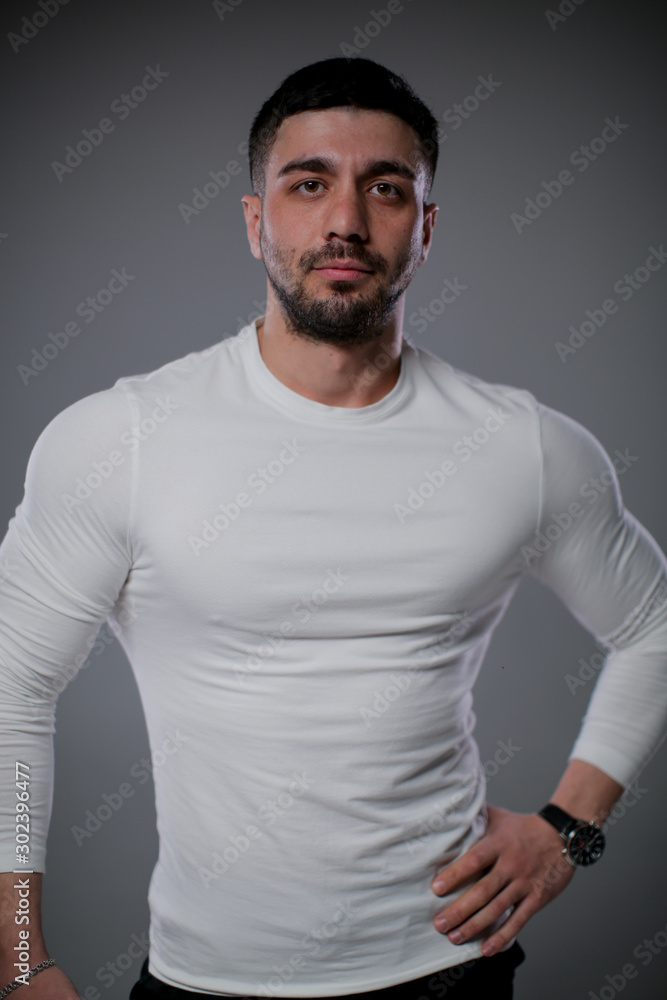 A beefy man in a white sweater.