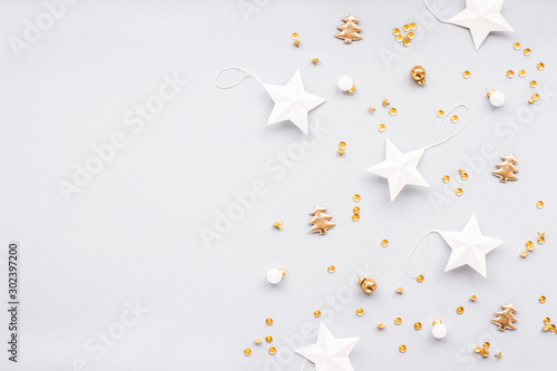 Gold and white christmas decoration on pastel blue background, flat lay, top view