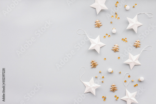 Gold and white christmas decoration on pastel blue background, flat lay, top view