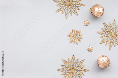 Gold christmas decoration on blue pastel background, top view, flat lay