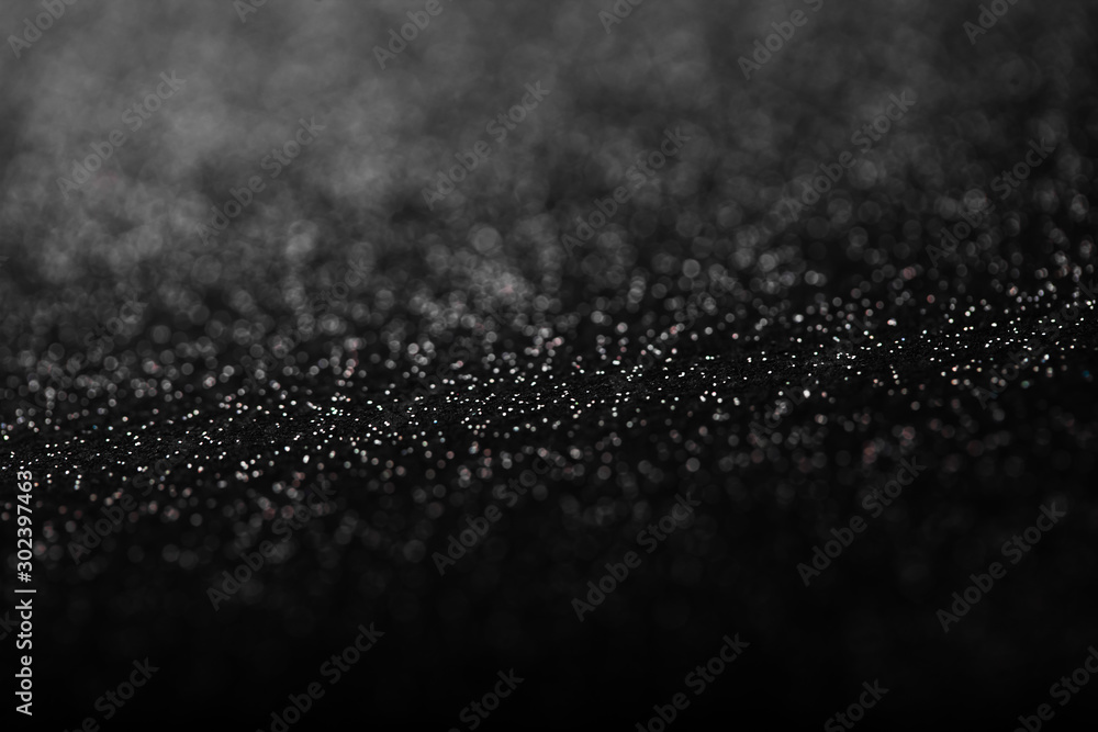 Black and white abstract background with small bokeh defocused lights. Black and white abstract background with small bokeh defocused lights.