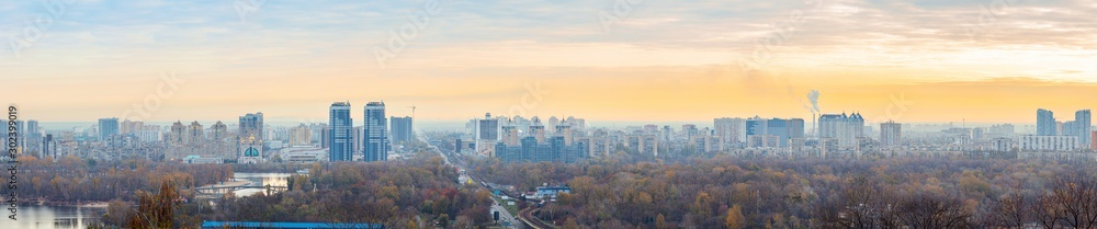 Panorama of Kyiv city and Dnipro river at sunrise in dawn, panoramic view to the colorful autumn cityscape in the morning, Ukraine