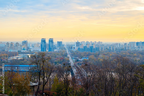 Panorama of Kyiv city and Dnipro river at sunrise in dawn, colorful autumn cityscape in the morning, Ukraine
