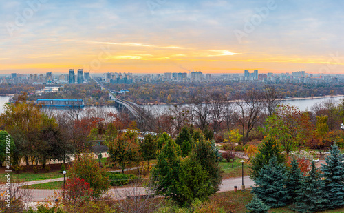 Panorama of Kyiv city and Dnipro river at sunrise in dawn, panoramic view to the colorful autumn cityscape in the morning, Ukraine © O.Farion
