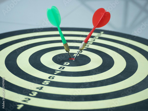 Red and Green dart target arrow hitting on bullseye which is the ultimate goal that everyone wants, Target marketing and business success concept