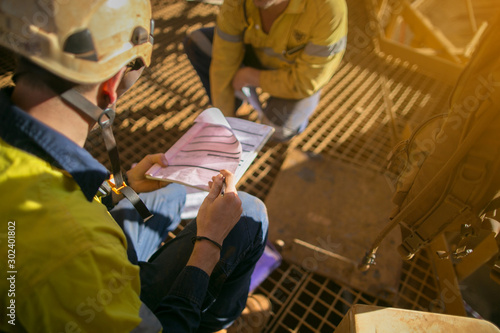 Foto Construction miner wearing safety helmet hand over defocused of confined space w