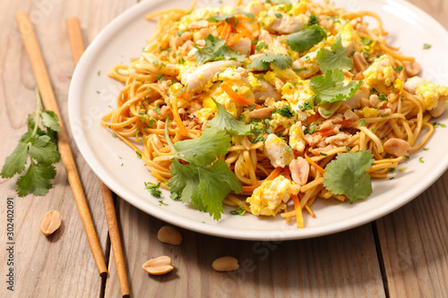 fried noodles with chicken, egg, chicken and herb