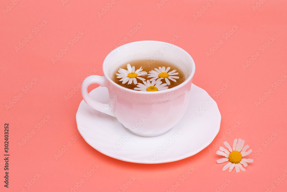 Tea with camomile in a white cup. Phytotea, healthy lifestyle Tea with camomile in a white cup. Phytotea, healthy lifestyle