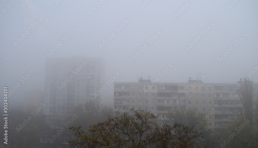 View of the city houses in the gray fog.
