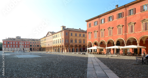 Italy /Modena – June 23, 2019: piazza della Torre in Modena is located at the foot of the Ghirlandina tower with a statue dedicated to Alessandro Tassoni, a writer and poet from Modena. photo