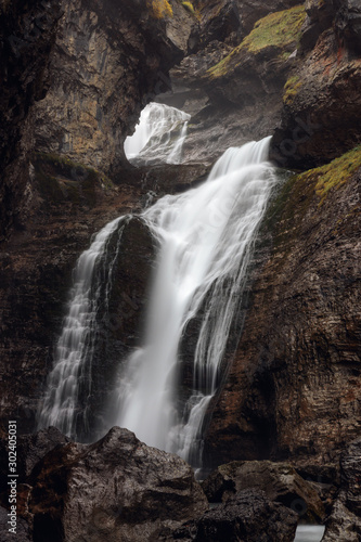 waterfall through a hole in the mountain