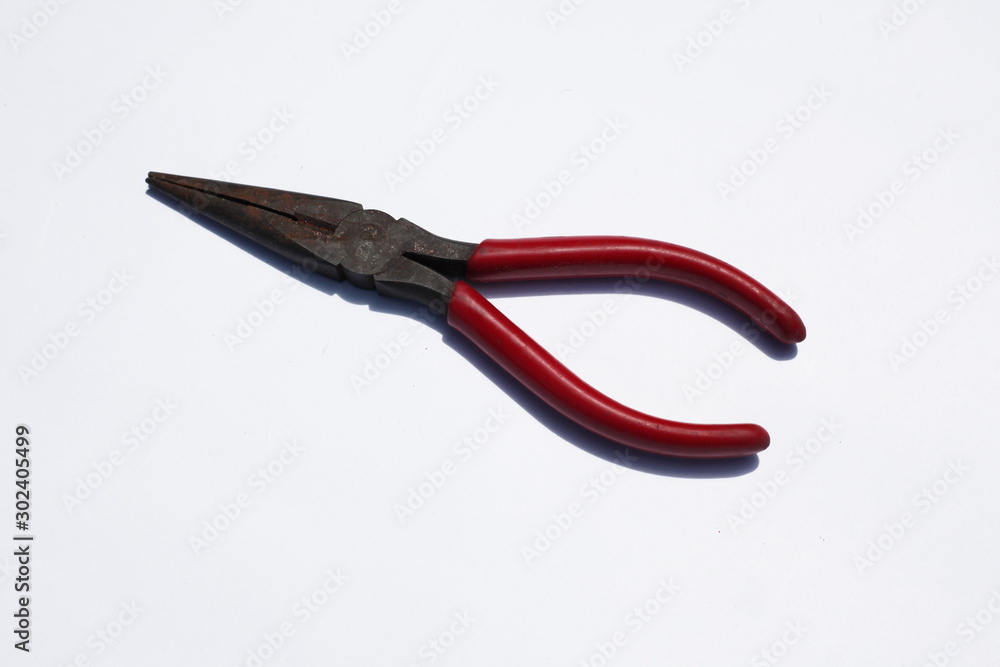 Red pliers on a white background Red pliers on a white background