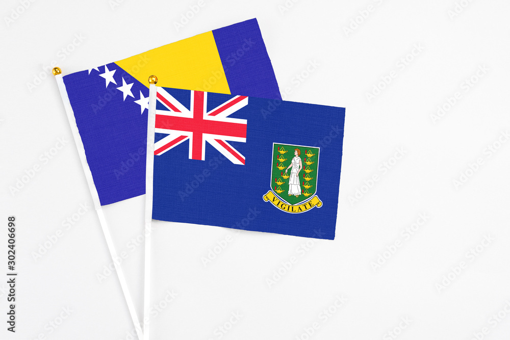 Fototapeta premium British Virgin Islands and Bosnia Herzegovina stick flags on white background. High quality fabric, miniature national flag. Peaceful global concept.White floor for copy space.