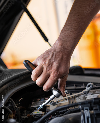 Picture of a man servicing the car