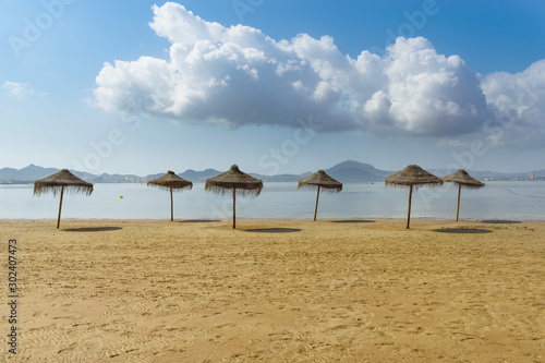 Umbrellas on the beach by the sea. La Manga del Mar Menor. Murcia, Spain © ANDREI