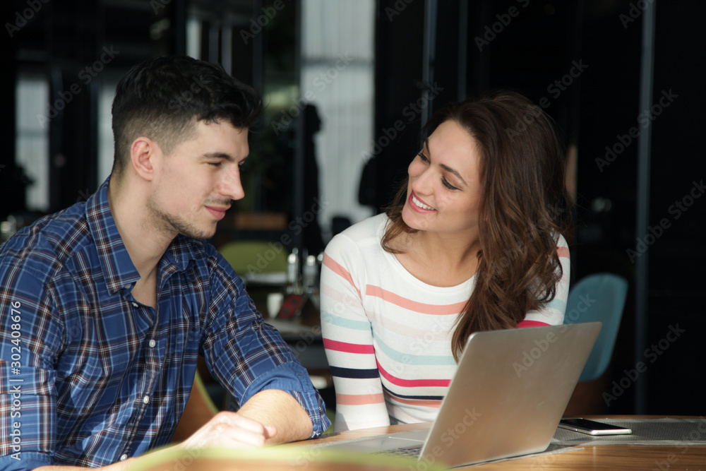 Young people looking at laptop together Young people looking at laptop together