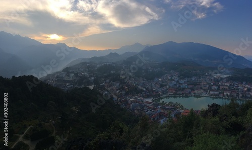 sunset in the mountains, aerial view of the city, Sapa city, North Vietnam, European style city view © Watthana Tirahimonch