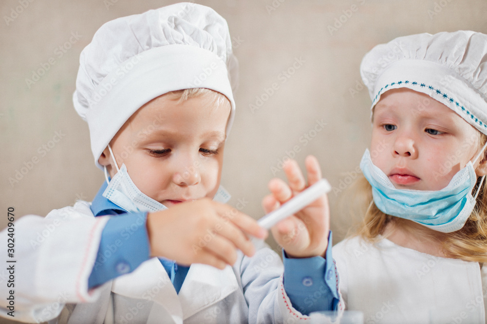 little children enthusiastically play doctors and treat toys little children enthusiastically play doctors and treat toys