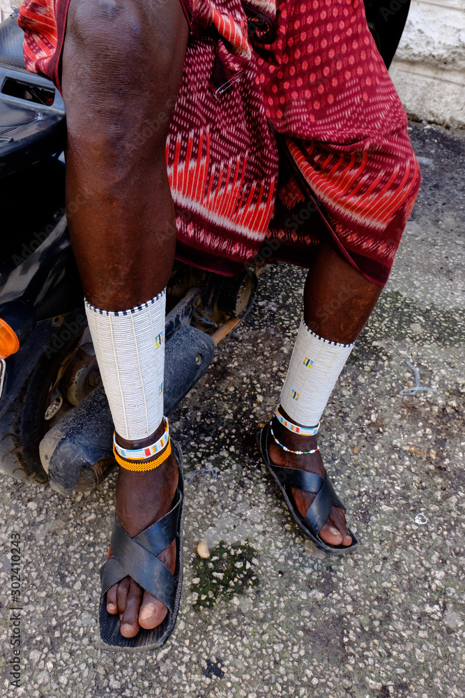 Masai cultural male sitting on his motorcycle with his traditional attire on Masai cultural male sitting on his motorcycle with his traditional attire on