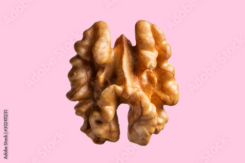 Canvas Print Peeled walnut isolated on colored pink backgroun