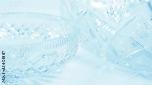 Transparent cut glass ware of  the various design and shapes, closeup, tinted light blue, 1960s photo