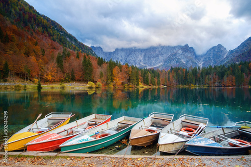 Alpine lake and colorful boats, Lake Fusine,Italy