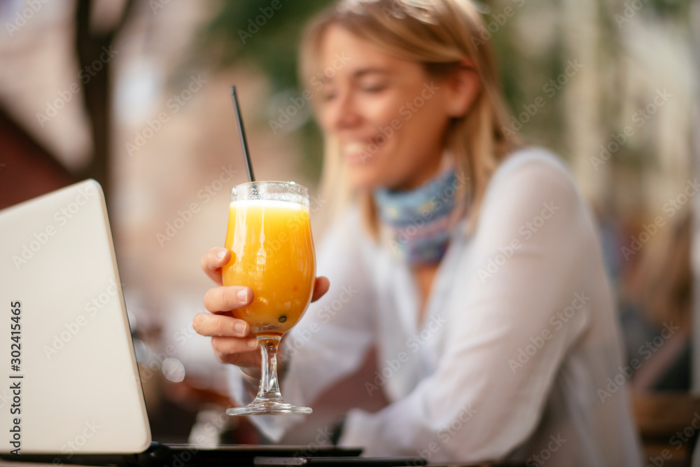 Young woman in cafe. Beautiful businesswoman drinking juice. Pretty student in cafe with lap top. Young woman in cafe. Beautiful businesswoman drinking juice. Pretty student in cafe with lap top.