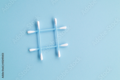 cotton swabs in the form of a hashtag on a blue background