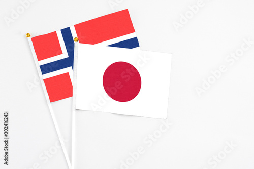 Japan and Bouvet Islands stick flags on white background. High quality fabric, miniature national flag. Peaceful global concept.White floor for copy space. Free Download Japan and Bouvet Islands stick flags on white background. High quality fabric, miniature national flag. Peaceful global concept.White floor for copy space. - GFXLoad