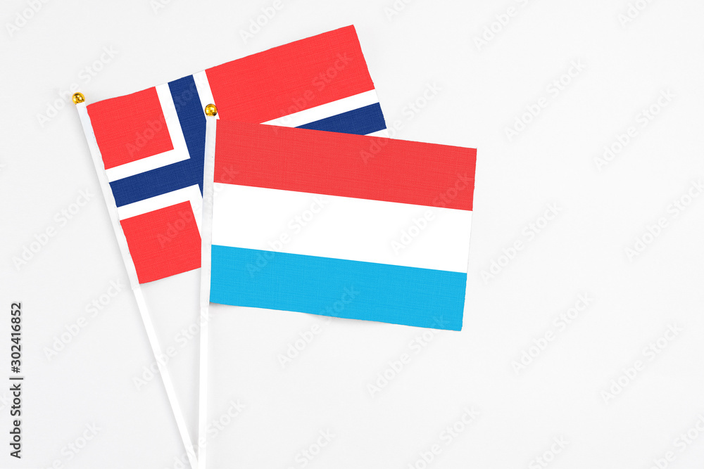 Luxembourg and Bouvet Islands stick flags on white background. High quality fabric, miniature national flag. Peaceful global concept.White floor for copy space. Luxembourg and Bouvet Islands stick flags on white background. High quality fabric, miniature national flag. Peaceful global concept.White floor for copy space.