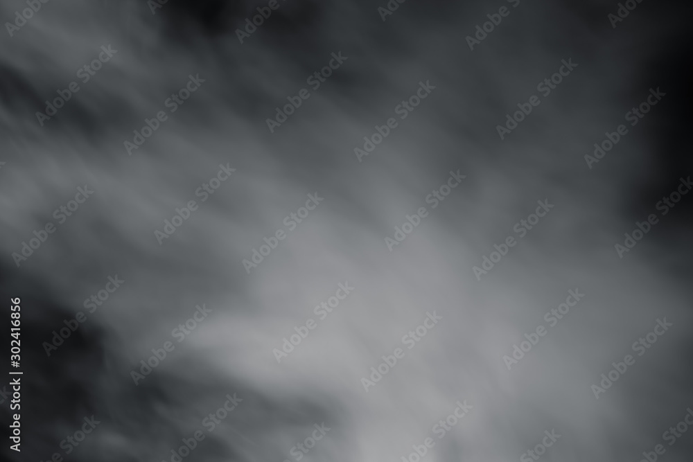 Fototapeta premium Smoke spray spread with wind on black background. Soft blur fog spread around